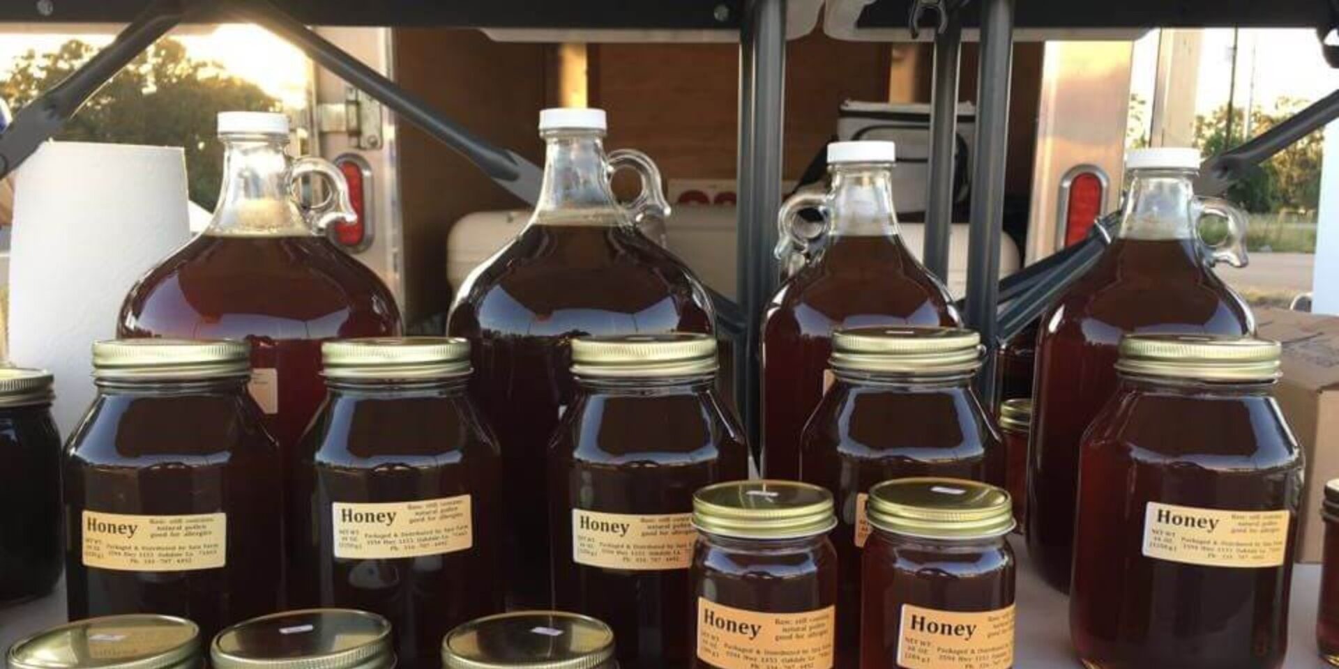 A group of jars and bottles filled with honey.