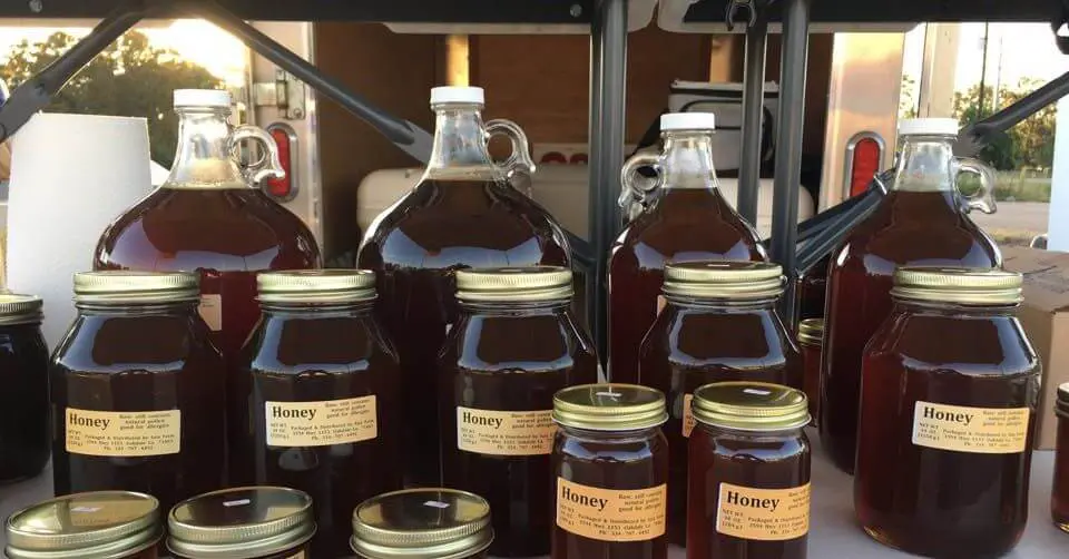 A group of jars and bottles filled with honey.