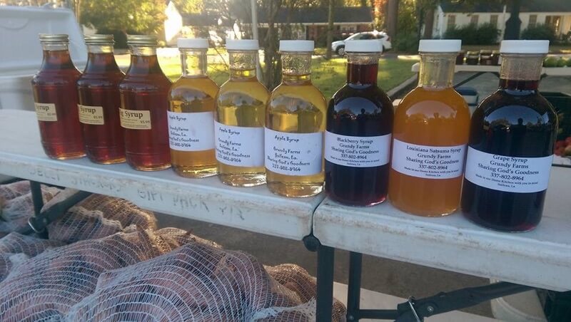 A row of bottles with different flavors of honey.